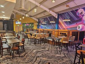 a restaurant with tables and chairs and a mural at Seascape Holiday Caravan in Tunstall