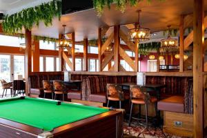 a pool table in a bar with chairs and tables at Seascape Holiday Caravan in Tunstall