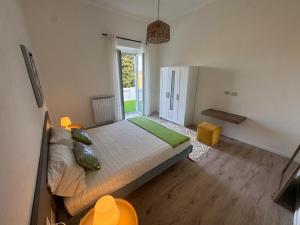 a bedroom with a large bed and a large window at Bella Ischia in Ischia