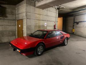 a red car parked in a parking garage at Charmant appartement hyper central, idéal pour couple ou petite famille, parking couvert in Crans-Montana