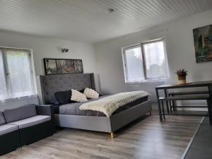 a bedroom with a bed and a table and a piano at casa de invitados estilo normandie in Chamblac +30 photos