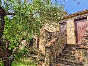 an old stone house with stairs and a door at La casa Monte Oliveto in Bettona +17 photos