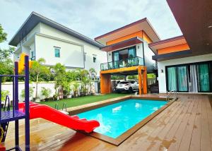 a house with a pool and a slide at Sha's House Pool Villa in Narathiwat