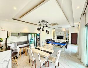 a living room with a ping pong table and a pool at Sha's House Pool Villa in Narathiwat