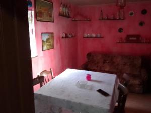 a table in a room with a red wall at Retro House in Bečej