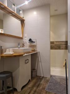 a bathroom with a sink and a shower at Le clos fleuri 