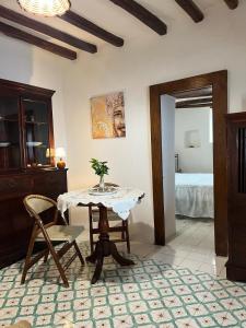 a dining room with a table and a bedroom at Traditional Eolian House Luna - Unique experience in San Salvatore
