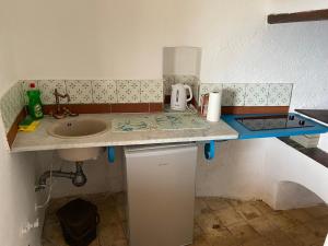 a small kitchen with a sink and a counter top at Traditional Eolian House Luna - Unique experience in San Salvatore +46 photos