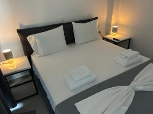 a bedroom with a bed with two towels on it at House Thomi in Skala Potamias +19 photos