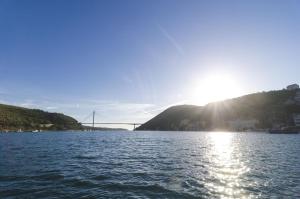 a large body of water with a bridge in the background at KiM in Mokošica +36 photos