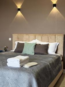 a bedroom with a large bed with towels on it at Квартира с видом на Усть-Каменогорск in Ustʼ-Kamenogorsk