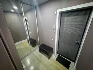 a bathroom with a shower and a glass shower stall at Квартира с видом на Усть-Каменогорск in Ustʼ-Kamenogorsk +2 photos