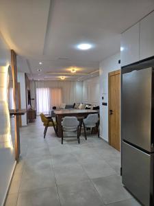 a kitchen and living room with a table and a dining room at Luxury appartment avec piscine à la Marina Saidia in Saidia 