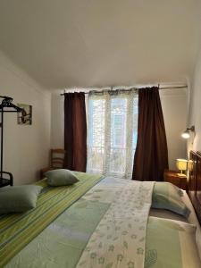 a bedroom with a large bed and a window at La maison colimaçon in Clans
