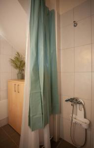 a shower curtain in a bathroom with a sink at Pyrgos Spring pool apartment in Maleme