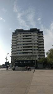 a large building with people sitting in front of it at T2 Praia in Póvoa de Varzim +6 photos