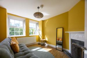 a living room with a couch and a fireplace at Talfryn Cottages in Betws-y-coed