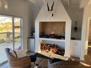 a fireplace in a living room with a fire place at Sea and Mountain View in Mossel Bay