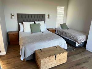 a bedroom with a large bed with a wooden box at Sea and Mountain View in Mossel Bay