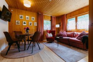 a living room with a couch and a table and chairs at LANDHAUS AnnMarie in Limbach im Burgenland