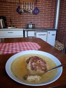 a bowl of soup on a table in a kitchen at Waldpoesie - Das Wald-Cottage in Benking