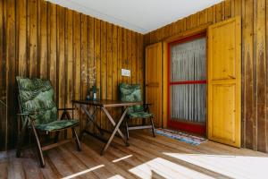 a room with two chairs and a table and a door at LANDHAUS AnnMarie in Limbach im Burgenland