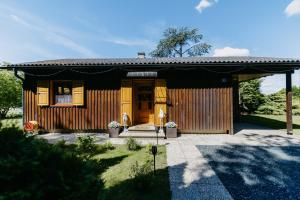 a small house with a black roof at LANDHAUS AnnMarie in Limbach im Burgenland