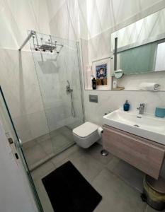 a bathroom with a shower and a toilet and a sink at Stylish Flat in Jewish District 7 in Budapest