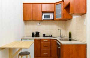 a small kitchen with a sink and a microwave at Stylish Flat in Jewish District 7 in Budapest +2 photos
