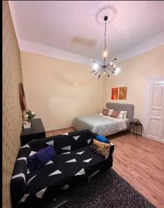 a living room with a couch and a bed at Stylish Flat in Jewish District 7 in Budapest