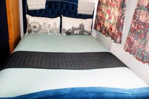a bed in the back of a small room at Central London rooms in London