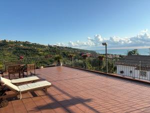 a patio with a bench and a table on a balcony at Le tre cose in Vasto