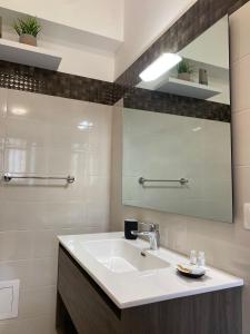a bathroom with a sink and a mirror at Empire B&B in Diamante +13 photos