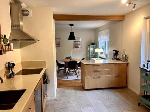 a kitchen with a table and a dining room at Stylish Villa, Terrace & Garden in Ljungby +23 photos