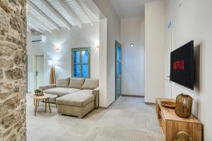 a living room with a couch and a table at NOA Village Apartments in Chios