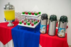a table with some drinks and a pitcher of juice at Hotel ITACO in Cartagena de Indias +17 photos