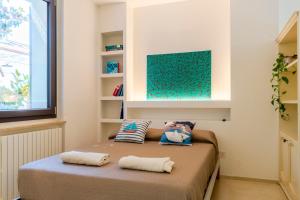 a bedroom with a bed with two pillows on it at Magnolia house- monolocale con ingresso indipendente in Civitanova Marche