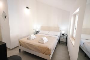 Postel nebo postele na pokoji v ubytování Domus Picena - Suites & Relax