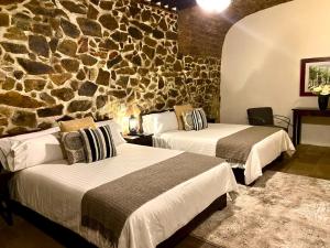 Voodi või voodid majutusasutuse HOTEL MINA REAL toas