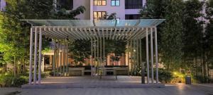 a pavilion in a park in front of a building at Agile super suite KLCC in Kuala Lumpur