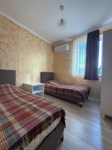 a hotel room with two beds and a window at Petra Tsikhisdziri in Ts'ikhisdziri