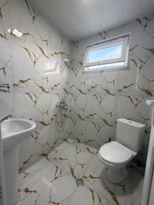 a bathroom with a toilet and a sink at Petra Tsikhisdziri in Ts'ikhisdziri +27 photos