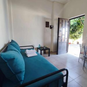 a bedroom with a bed and a door to a patio at Limanaki in Kymi