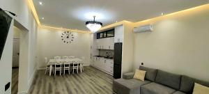 a living room with a couch and a dining room at Villa qəbələ in Gabala