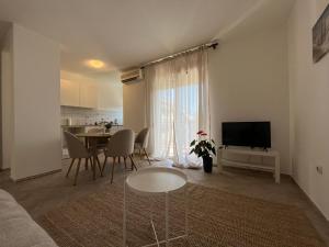 a living room with a table and a dining room at Galeb in Igalo