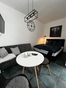 a living room with a couch and a table at Elephant Apartman in Komárno
