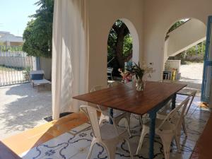 a dining room with a wooden table and chairs at Villa Lucky in Punta Prosciutto
