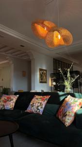 a green couch in a living room with two pillows at Hotel los Tilos in Beteta