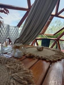 a wooden table with a table cloth on it at Glamping il Tramonto in Villa Amancay