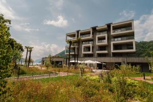 a building with a garden in front of it at Swiss Diamond Boutique Hotel - La Romantica in Melide